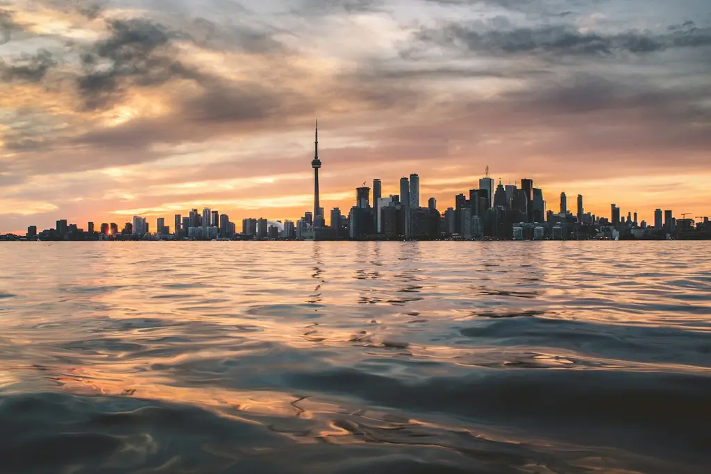 The Toronto skyline and CN Tower seen across the water at sunset
